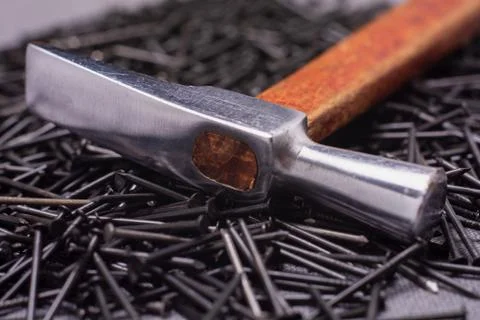Hammer on nails close-up Stock Photos