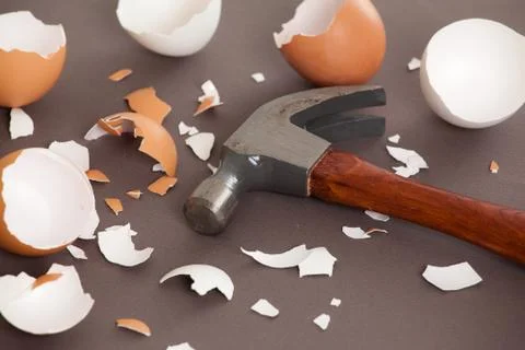 Hammer next to a bunch of cracked shells Stock Photos