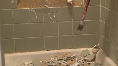 Hammer pounds across tile wall of shower. Stock Footage 35404510