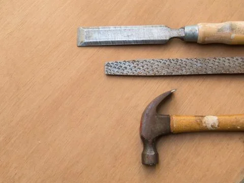 Hammer, rasp and chisel for carpentry, on wooden table Foto stock