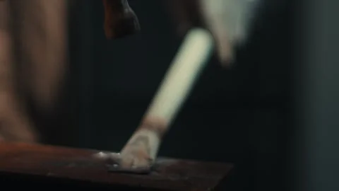 Hammer striking metal piece on workbench during fabrication close up Stock Footage 331900247