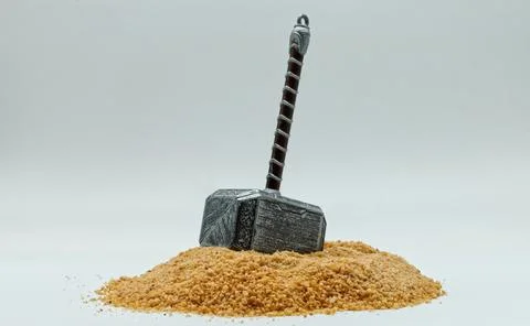 Hammer of Thor, Mjolnir, on the ground isolated on white background. Stock Photos