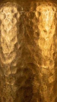 Hammered gold surface with deep texture and subtle cracks, illuminated for .. Фото