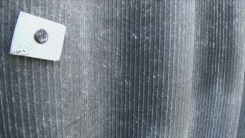 A hammered nail in a striped slate Stock Footage 185051189