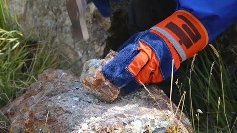 Hammering with a geologists hammer on stone Stock Footage 79470464