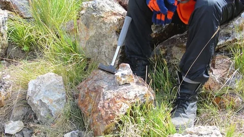 Hammering with a geologists hammer on stone Stock Footage 83516779