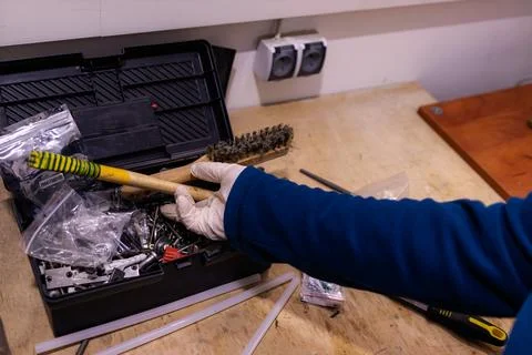 Hammering Metal Pin into Component Fixed in Bench Vise, Manual Assembly Work in Foto stock