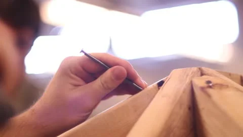 Hammering nail into boards Stock Footage 10591272