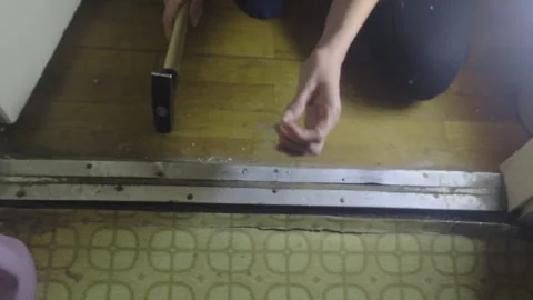 Hammering Nail into Floor Mistake During Home Renovation Falling Nail DIY Fail Stock Footage 331154648