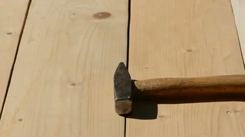 Hammering nail in garden table board Stock Footage 10918987
