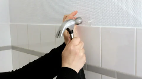 Hammering a nail into wall Stock Footage 38286195