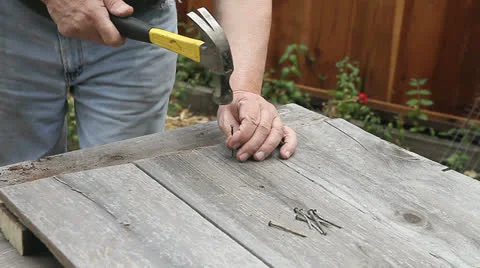 Hammering nails into boards Stock Footage 24829945