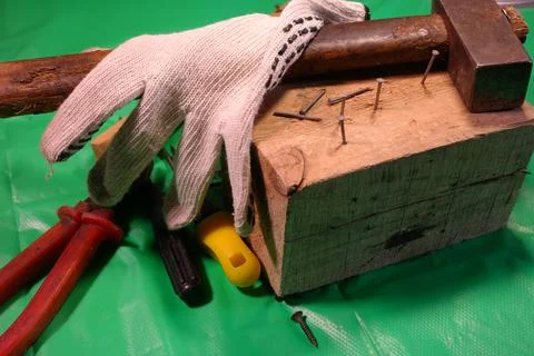 Hammering nails. Using a hammer and a nail. Close up of hammering a nail into Stock Photos