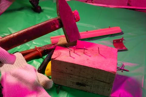Hammering nails. Using a hammer and a nail. Close up of hammering a nail into Fotos Stock