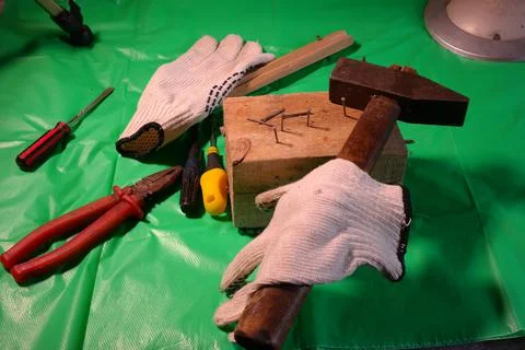 Hammering nails. Using a hammer and a nail. Close up of hammering a nail into Stock Photos