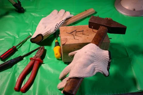 Hammering nails. Using a hammer and a nail. Close up of hammering a nail into Stock Photos