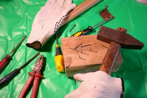 Hammering nails. Using a hammer and a nail. Close up of hammering a nail into Фото