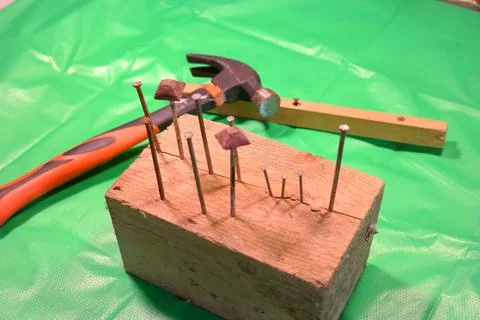Hammering nails. Using a hammer and a nail. Close up of hammering a nail into Foto stock