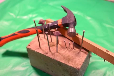 Hammering nails. Using a hammer and a nail. Close up of hammering a nail into Foto stock