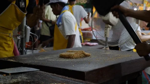 Hammering peanuts to make Khanom Tup Tap peanut snacks, traditional Thai Stock Footage 98133331