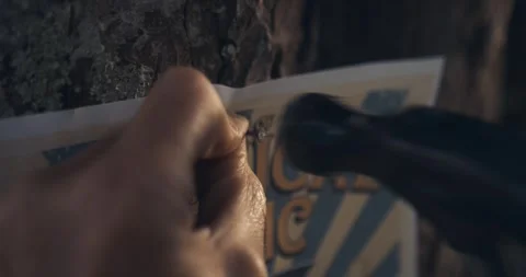 Hammering a poster to a tree 動画素材 285153584