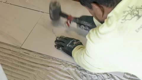 Hammering the tiles Stock Footage 284408368