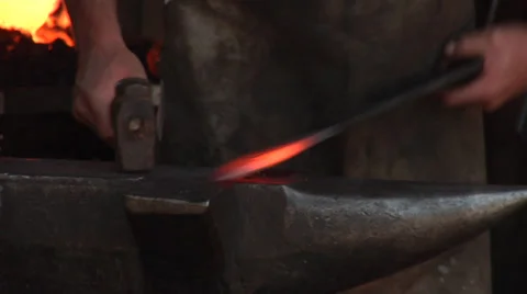 Hammerman, smith, blacksmith forges iron in traditional costume Stock Footage 31969330