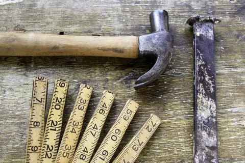Hammers lined up on aged wood Stock Photos