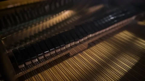 The hammers strike the strings of the grand piano Stock Footage 64460660
