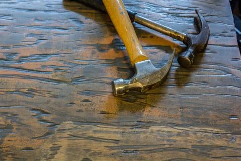 Hammers on a wood surface Stock Photos
