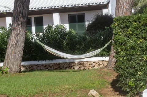 Hammock anchored between two trees Stock Photos