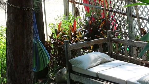 Hammock and wooden bench on backyard in windy day Stock Footage 83760946