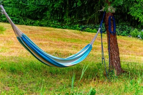 Hammock between two trees invites you to relax Stock Photos