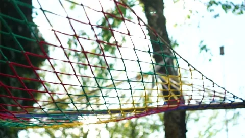 Hammock colorful net swinging on tree at summer at sunset Vídeo Stock 243939435