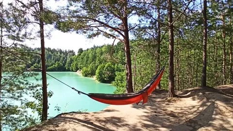 A hammock in the forest. Fresh air, relaxation. Picnic in nature Stock Footage 235939606