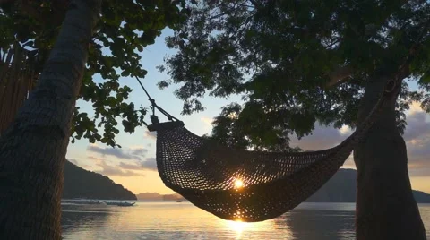 Hammock at sunset on the beach. Slow motion Video stock 63765015