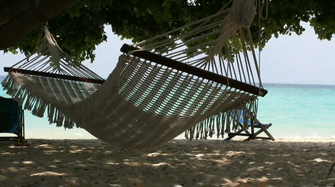 Hammock sways with the ocean breeze Stock Footage 664297