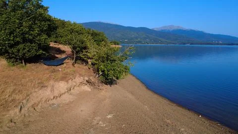 Hammock Under Trees by Tranquil Lake Shore Stock Photos