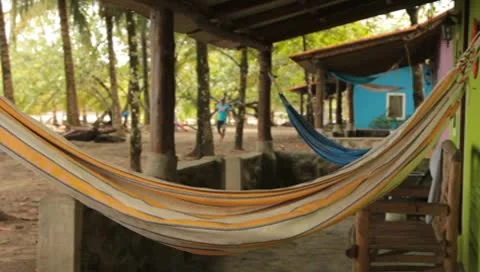 Hammocks hanging on porches of colorful beach houses Stock Footage