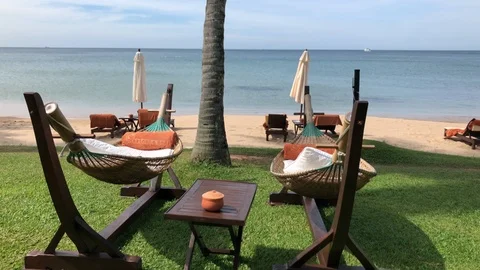 Hammocks sway in the wind at beautiful beach resort in Vietnam Stock Footage 107572676