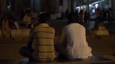 HAMPI, India - men sit in the outer Sri Virupaksha Temple courtyard at night Stock Footage 85127946