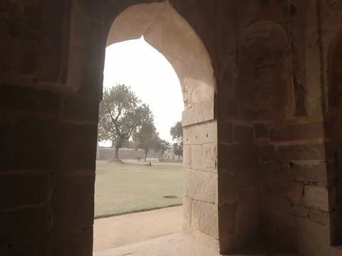 HAMPI, India - walking through the inner arches of the ancient Elephant Stables Stock Footage 85133999
