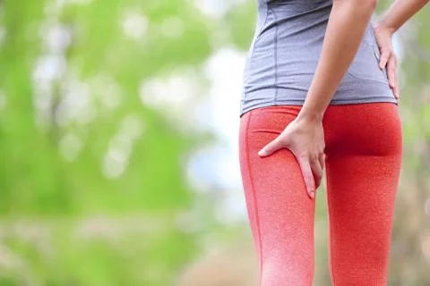 Hamstring sprain or cramps - Running sports injury Stock Photos