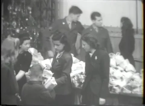 HANAU, GERMANY - 1947: Gift sorting - Women arrange parcels at a holiday table Stock Footage 344488366