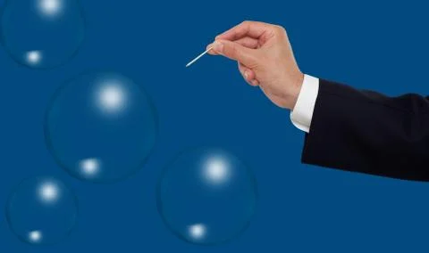 Hand about to burst a bubble with needle Foto stock
