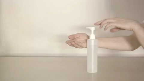 Hand action using disinfectant gel spray on a white background table Stock Footage 135065372