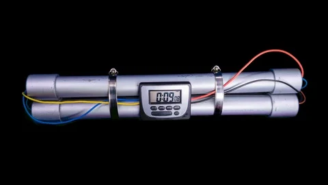 Hand activates pipebomb with countdown timer counting down to zero on black b Stock Footage 100406396