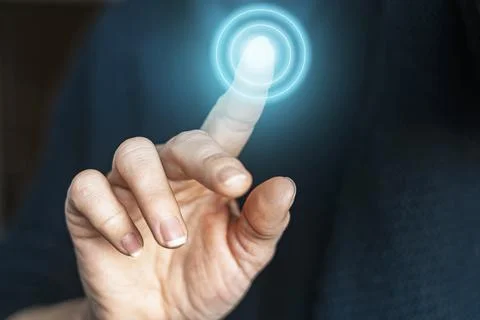 A hand is activating a button with a finger gesture Stock Photos