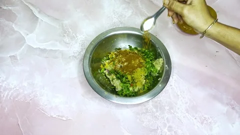 Hand added spices to a dish at indian kitchen Stock Footage 314178135