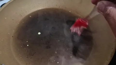 Hand Adding Butter to Hot Frying Pan During Food Preparation Video stock 336517829